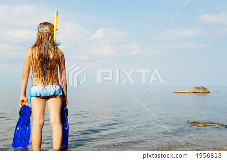 The girl on seacoast looks in a distance The girl on seacoast looks in a distance 4956818