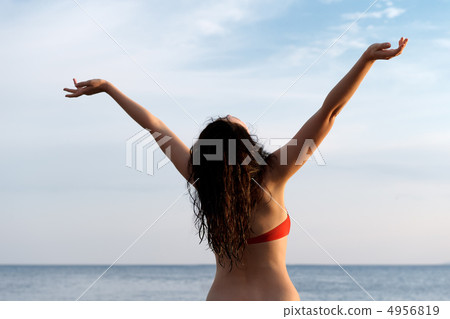 The girl on seacoast with the lifted hands The girl on seacoast with the lifted hands 4956819