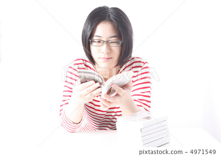 A woman who reads a book and a pile of books 4971549