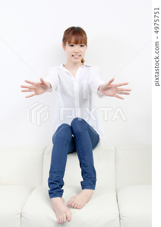 A young woman putting both hands forward A young woman putting both hands forward 4975751