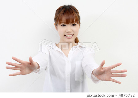 A young woman putting both hands forward A young woman putting both hands forward 4975752