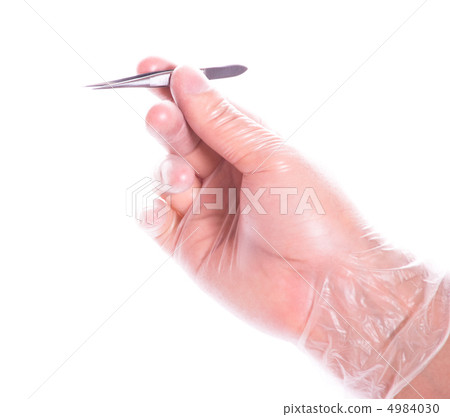 hand in rubber glove holding tweezers 4984030