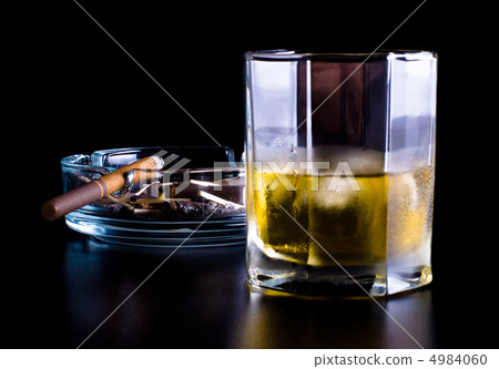 ashtray full of butts and glass of whiskey ashtray full of butts and glass of whiskey 4984060