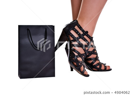 women legs in wreathy shoes stand behind bag women legs in wreathy shoes stand behind bag 4984062