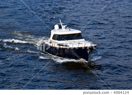 fast white motor boat on blue water fast white motor boat on blue water 4984124