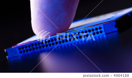 finger on flash card in blue light closeup 4984188