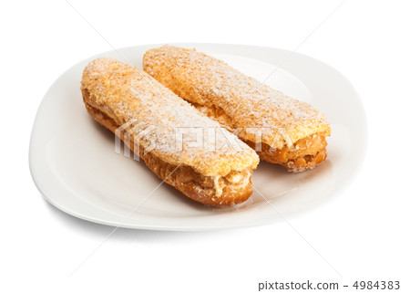 two tasty eclairs on dish 4984383