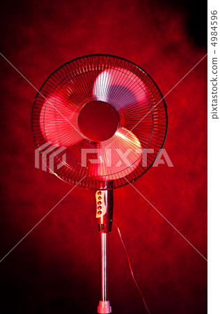 office fan on dark red background office fan on dark red background 4984596