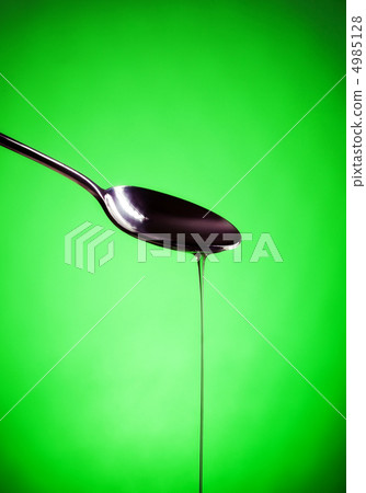 oil spill out of spoon oil spill out of spoon 4985128