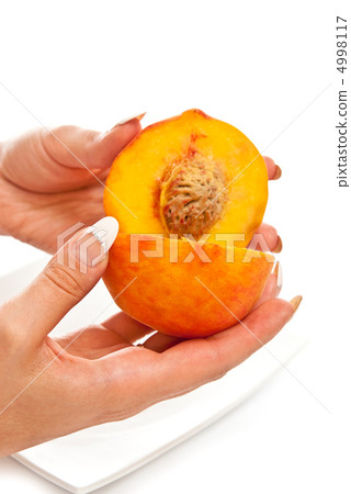 Peach in female hands 4998117