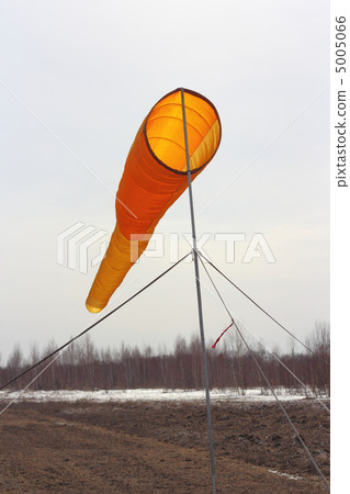 Wind direction Flag on blue cloud sky in wind Wind direction Flag on blue cloud sky in wind 5005066