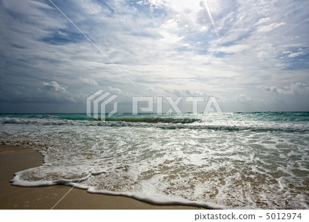 Golden shore hit by surf Golden shore hit by surf 5012974