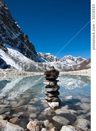 Harmony: Stone stack and Sacred Lake near Gokyo 5018583