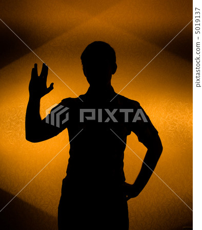 Back lit silhouette of man with raised hand Back lit silhouette of man with raised hand 5019137