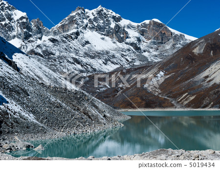 Sacred Lake and mountain peaks near Gokyo in Himalayas 5019434