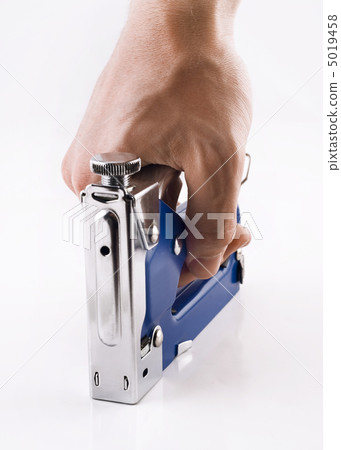 Staple gun in man's arm over white Staple gun in man's arm over white 5019458