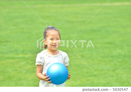 Girl playing ball at lawn open space 5030547