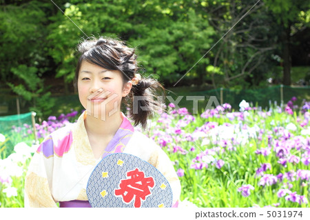 A girl in a yukata with a fan 5031974