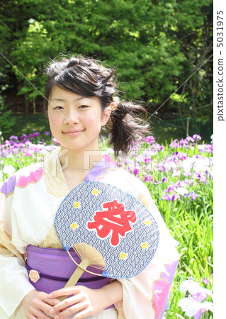 A girl in a yukata with a fan 5031975