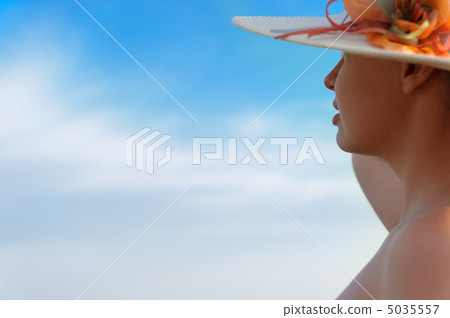 The girl in a hat against the blue sky The girl in a hat against the blue sky 5035557