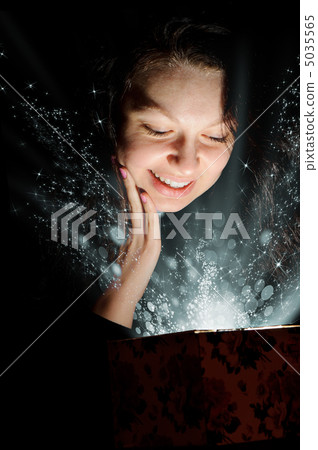 The woman with abstract light from a gift box The woman with abstract light from a gift box 5035565