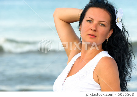The woman in a white sundress on seacoast. The woman in a white sundress on seacoast. 5035568