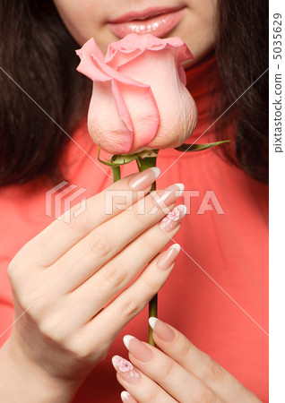 The woman with a rose closeup The woman with a rose closeup 5035629