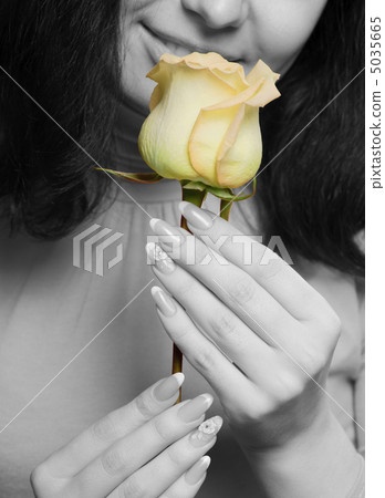 The woman with a yellow rose closeup The woman with a yellow rose closeup 5035665
