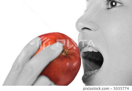The girl taking a bite an apple 5035774
