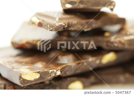 stacks of pieces of chocolate isolated on white stacks of pieces of chocolate isolated on white 5047367