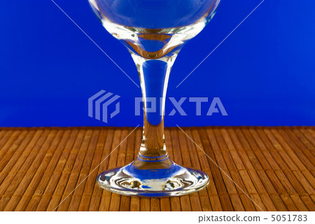 conceptually lighted wine glass on a multicolored background 5051783