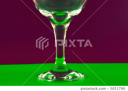 conceptually lighted wine glass on a multicolored background 5051790