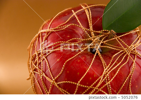 red apple on a gold background red apple on a gold background 5052076