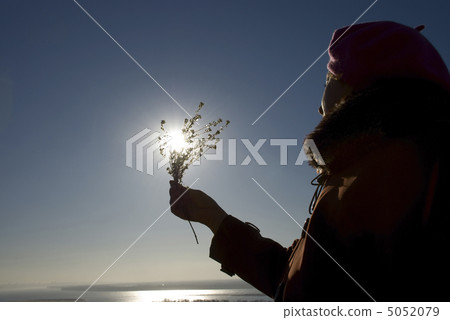 woman with a flower in the sun woman with a flower in the sun 5052079