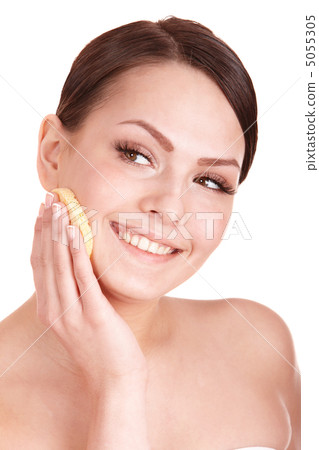 Young woman washing her face by sponge. Young woman washing her face by sponge. 5055305