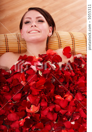 Young woman in rose petal swim water. Young woman in rose petal swim water. 5055311