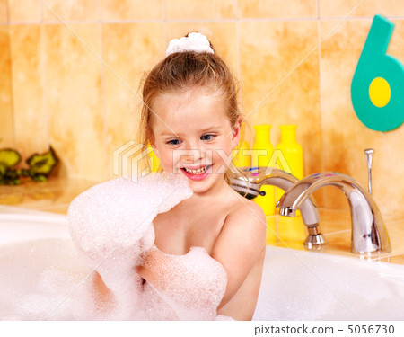 Child washing in bubble bath . 5056730