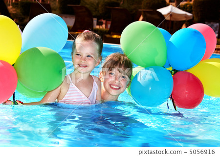 Children playing with balloons in swimming pool. 5056916