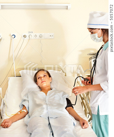 Doctor treats patient with stethoscope. 5057072