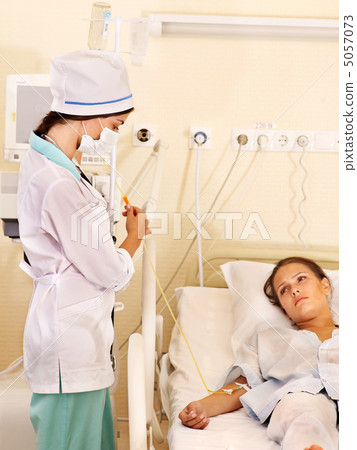 Doctor treats patient with stethoscope. 5057073