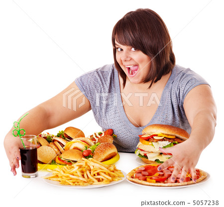 Woman eating fast food. 5057238