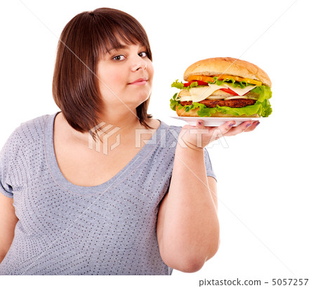Woman eating hamburger. Woman eating hamburger. 5057257