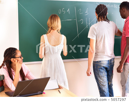 Student in classroom near blackboard. Student in classroom near blackboard. 5057297