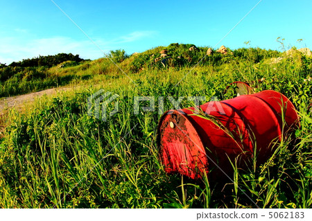 Drum cans thrown away on the grassland 5062183