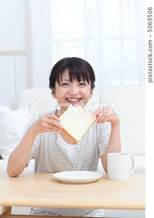 A woman eating bread 5069506