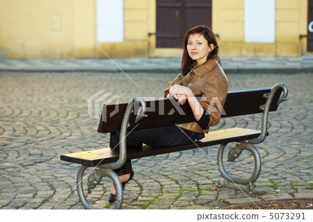 beautiful young woman sitting on a bench beautiful young woman sitting on a bench 5073291