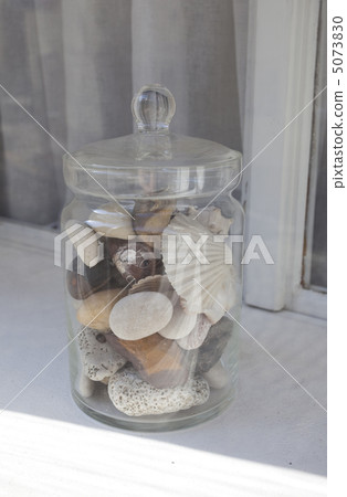 Bank of stones and shells on the windowsill 5073830