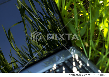 laptop on the green grass 5074066