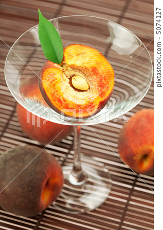 peach in the martini glass on a bamboo mat peach in the martini glass on a bamboo mat 5074127