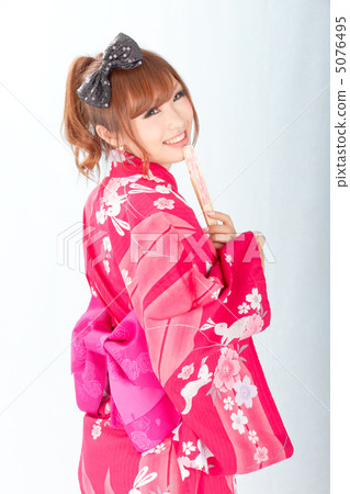 有一張微笑的面孔的一個女孩在轉回去的yukata 5076495